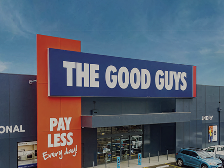 Exterior view of The Good Guys electronics retail store exterior with blue and white signage and red 'Pay Less Every Day' slogan