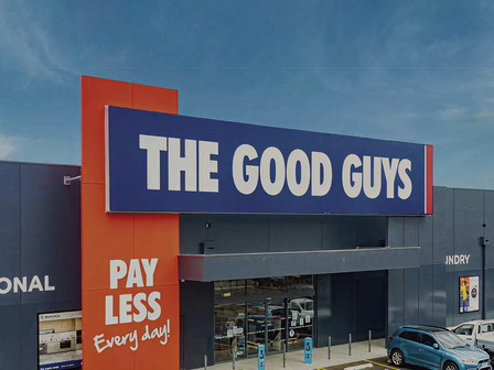Exterior view of The Good Guys electronics retail store exterior with blue and white signage and red 'Pay Less Every Day' slogan
