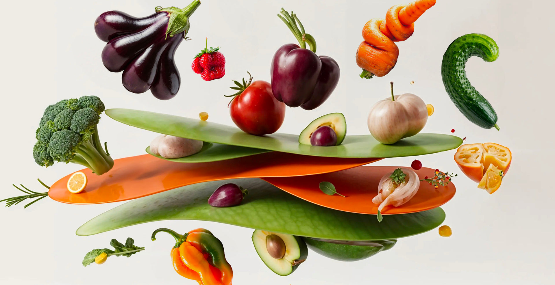 Fruits and vegetables arranged on a reflective surface with a neutral background
