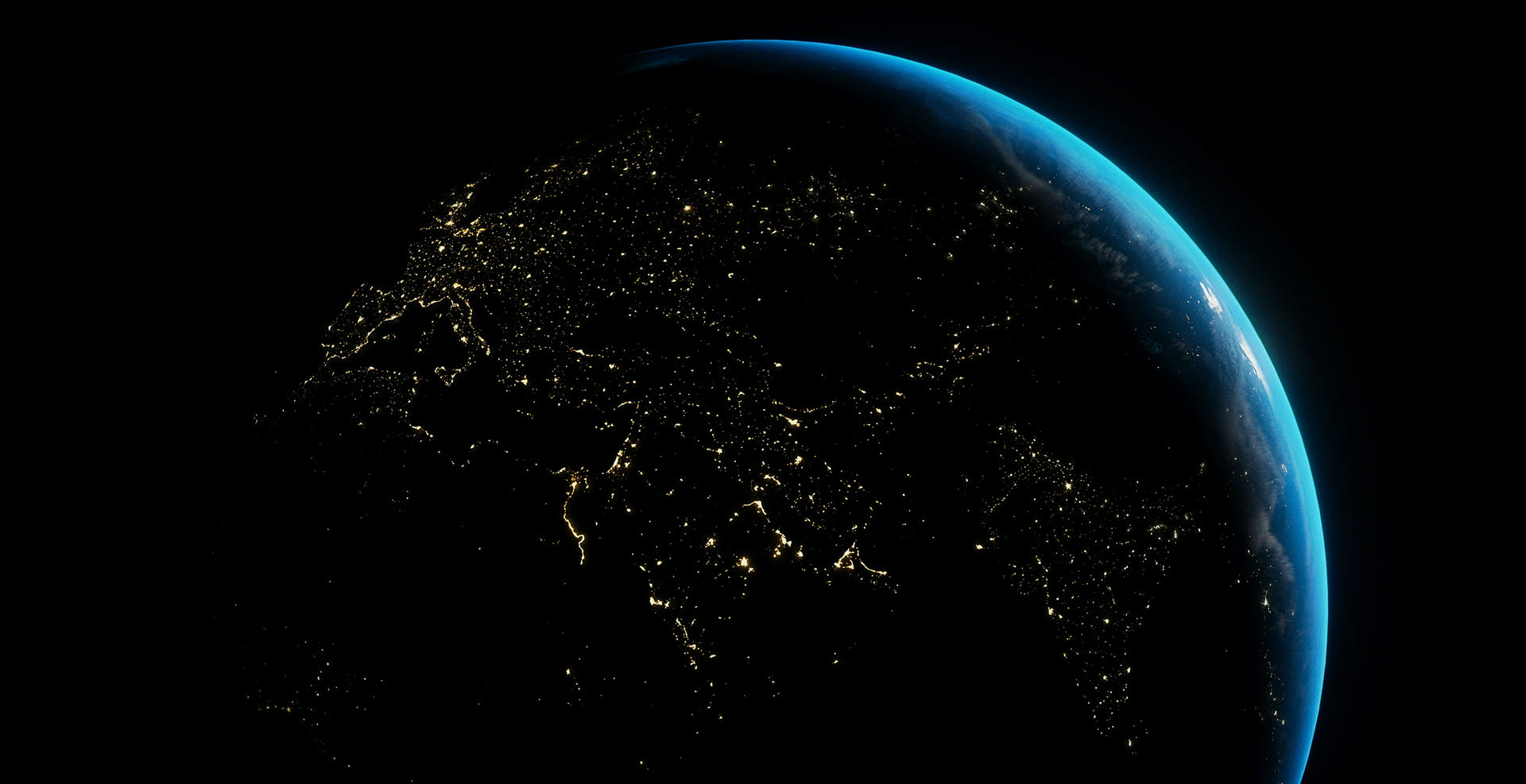 Earth at night from space, showing illuminated cities.