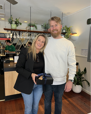 Two people posing in casual restaurant interior
