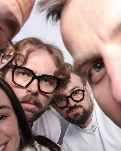 Close-up of four people with a focus on their facial expressions and glasses.