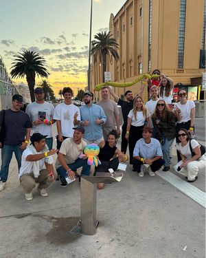 Large group photo at sunset gathering with palm trees