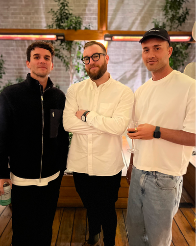 Three people at networking event in industrial loft space