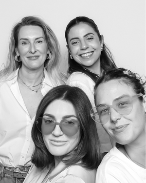 Black and white portrait of four women in photo booth